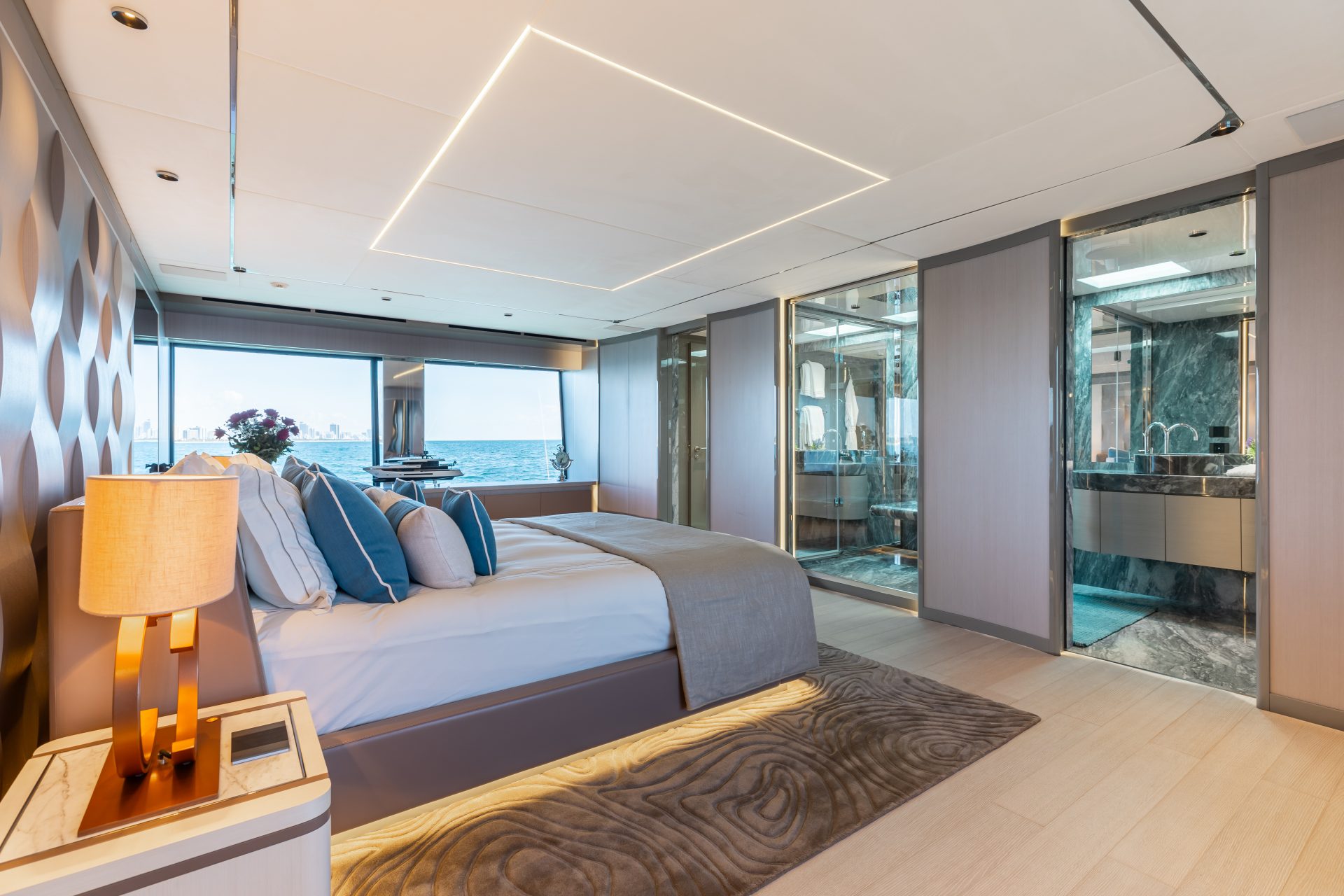 Luxurious yacht bedroom with ocean view.