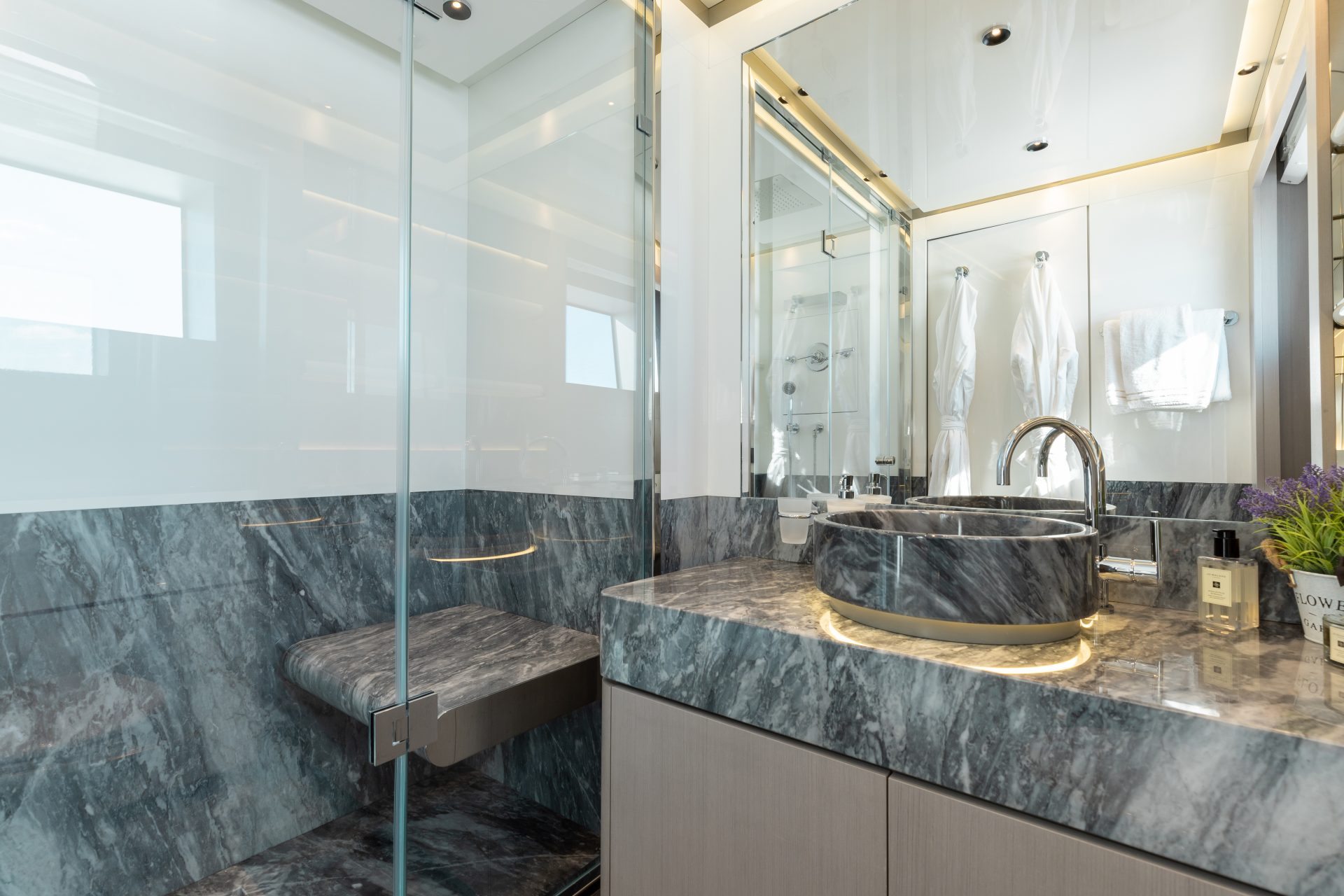 Luxury yacht bathroom with marble sink and shower.