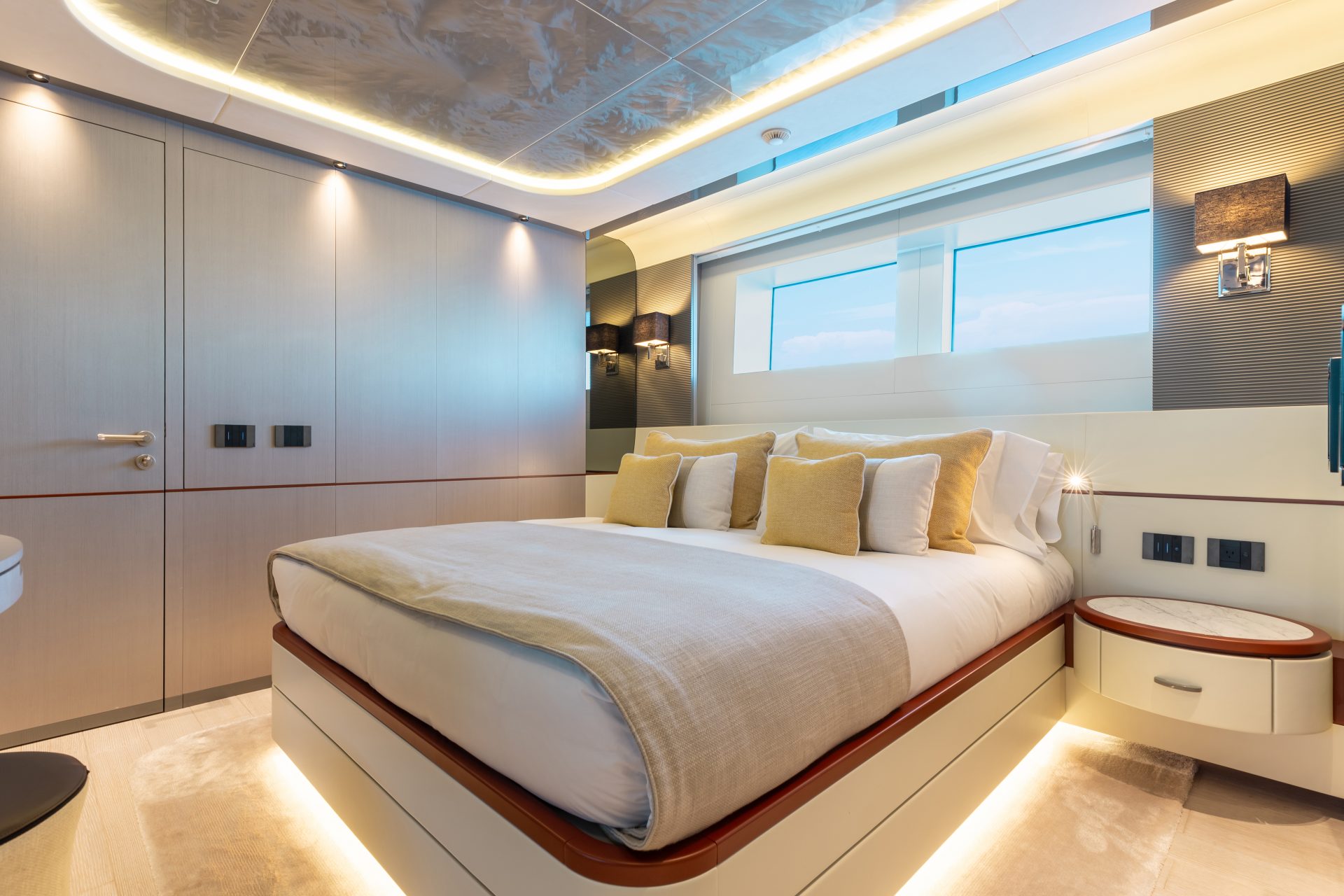 Luxury yacht bedroom with modern lighting.